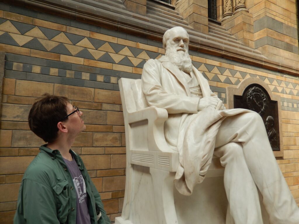 Zachary Blount gazing at Darwin statue